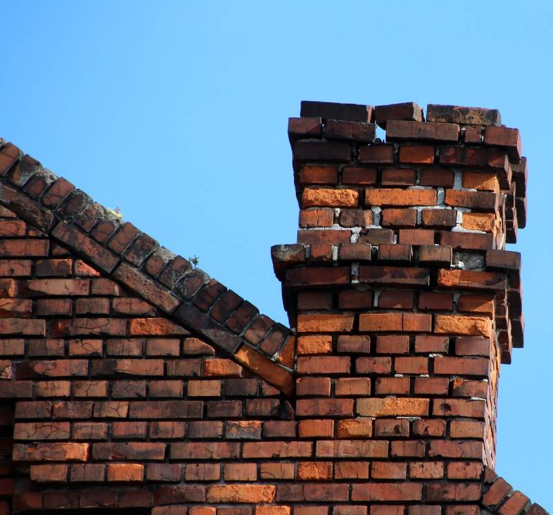 Signs Your Burleson Home Needs a Chimney Inspection Damaged chimney on an Burleson home showing cracks and missing mortar